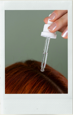 Scalp treatment being applied with a dropper