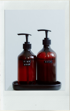 Two amber pump bottles on a tray